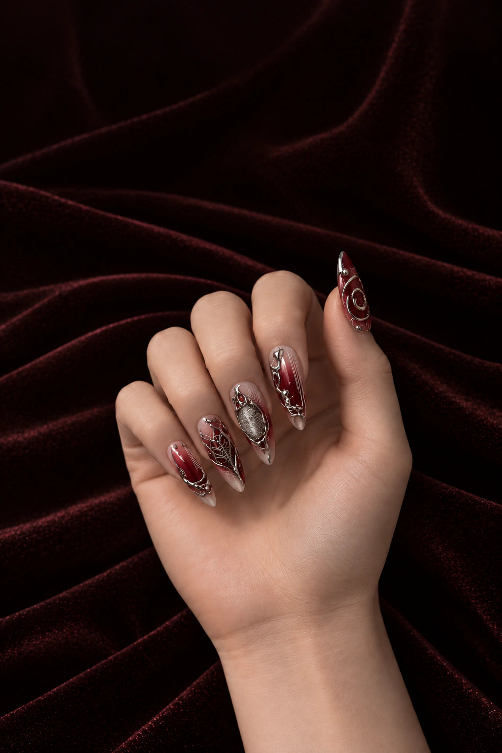 Sculpted Rouge press-on nails with silver and red sculptural art