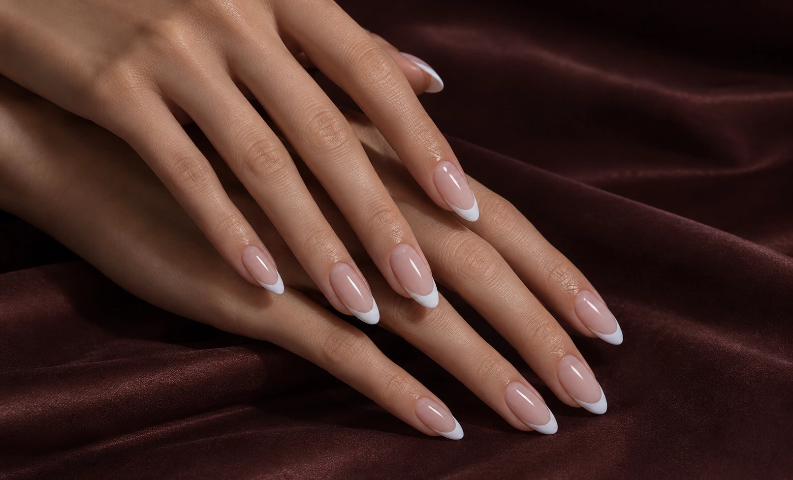 Close view of soft pink French nails for shape and length comparison